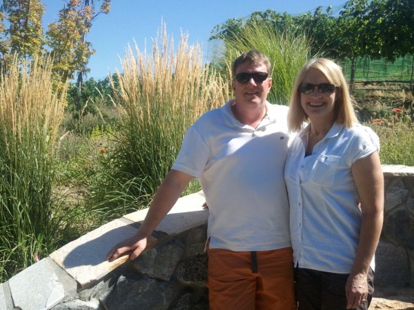 a man standing in front of a tree posing for the camera