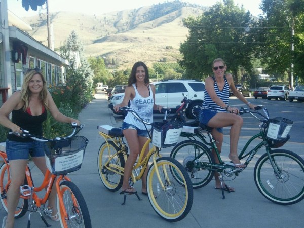 a group of people riding on the back of a bicycle