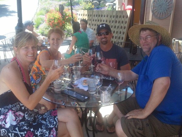 a group of people sitting at a table with wine glasses