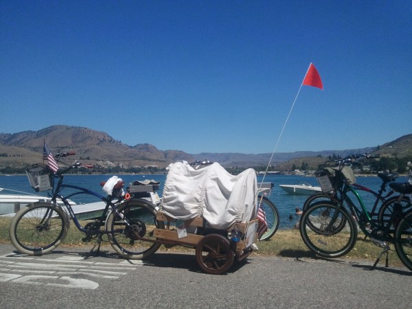 a group of people riding on the back of a bicycle