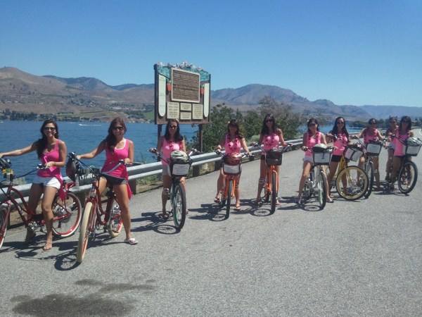 a group of people riding on the back of a bicycle