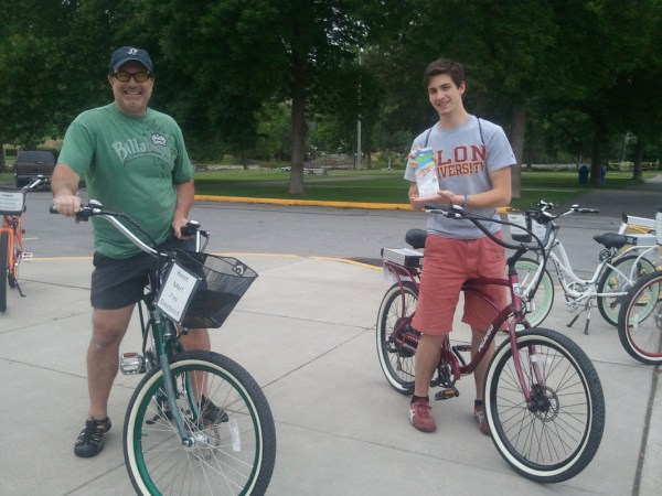 a group of people riding on the back of a bicycle