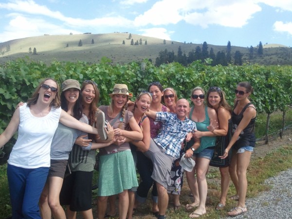 a group of people standing in front of a crowd posing for the camera