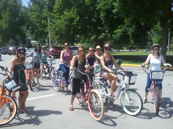 a group of people riding on the back of a bicycle