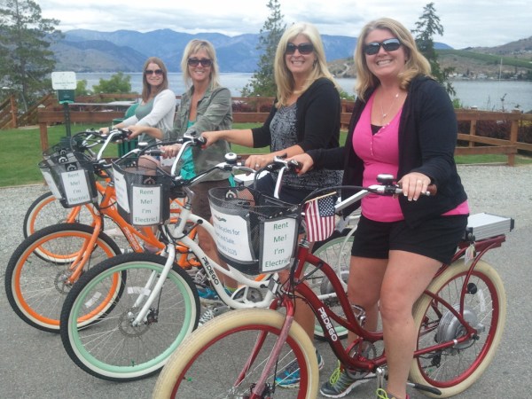 a woman riding on the back of a bicycle