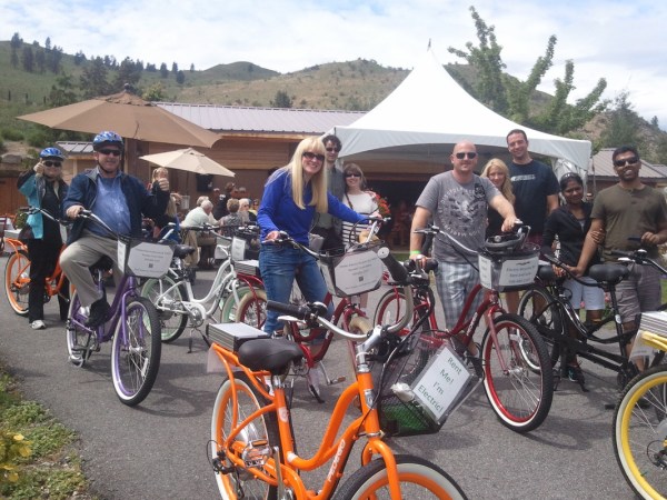 a group of people standing next to a bicycle