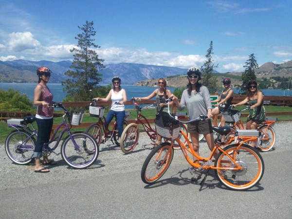 a group of people riding on the back of a bicycle