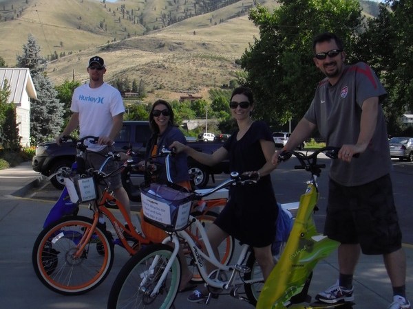 a group of people standing next to a bicycle