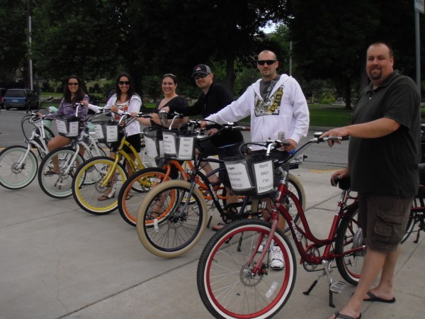 a group of people standing next to a bicycle