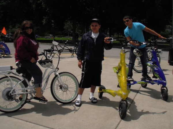 a group of people riding on the back of a bicycle
