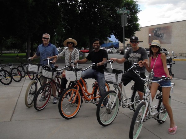 a group of people riding on the back of a bicycle
