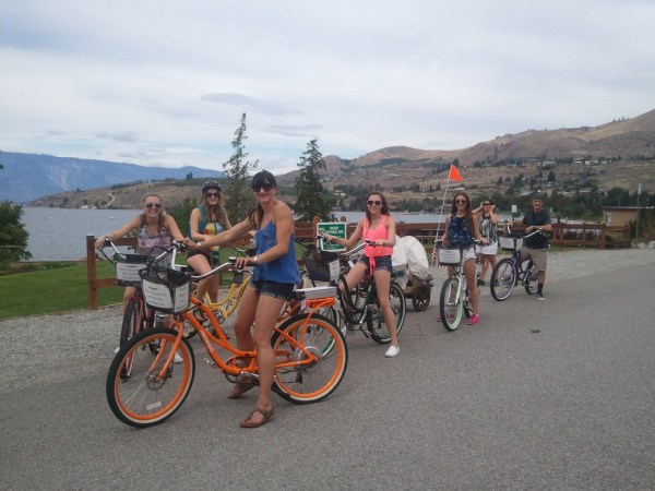 a group of people riding on the back of a bicycle