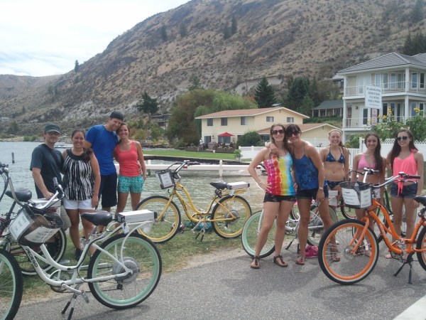 a group of people riding on the back of a bicycle