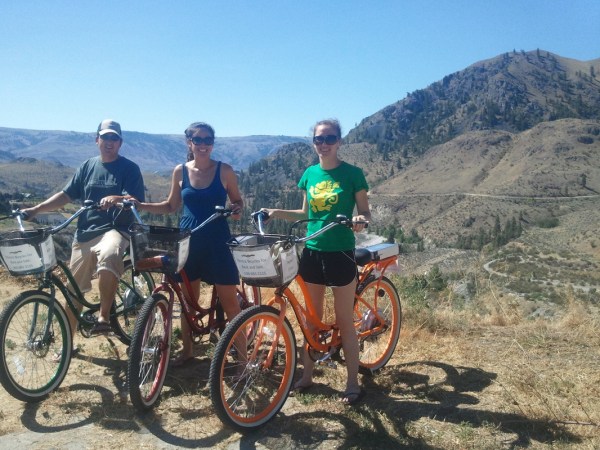 a group of people riding on the back of a bicycle