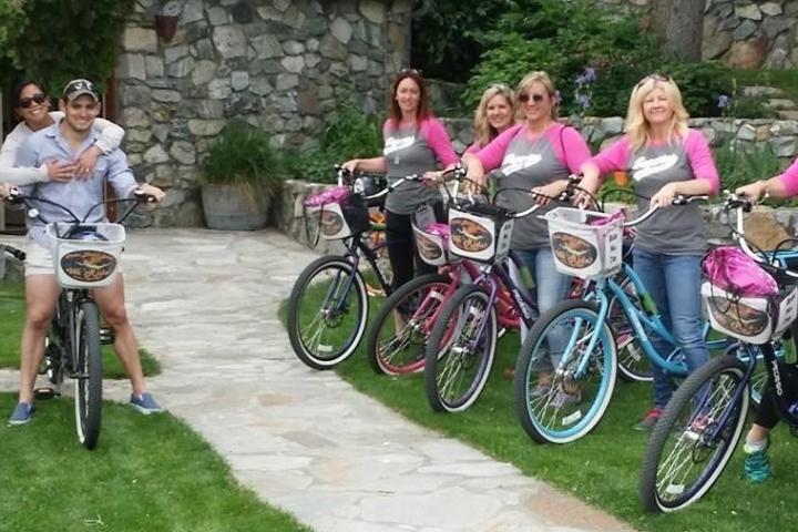 a group of people riding on the back of a bicycle