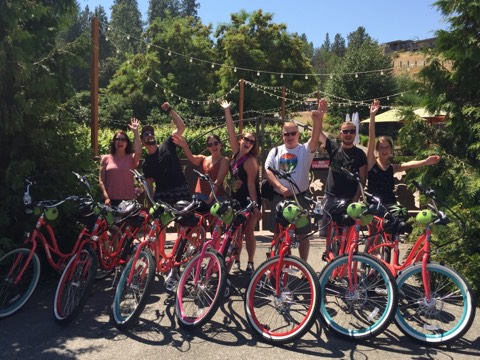 a group of people riding on the back of a bicycle