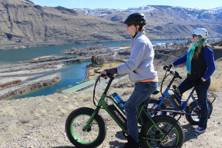 a person flying through the air while riding a motorcycle on a beach