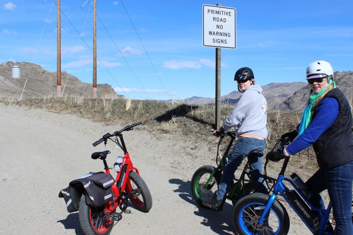 a group of people sitting on a motorcycle